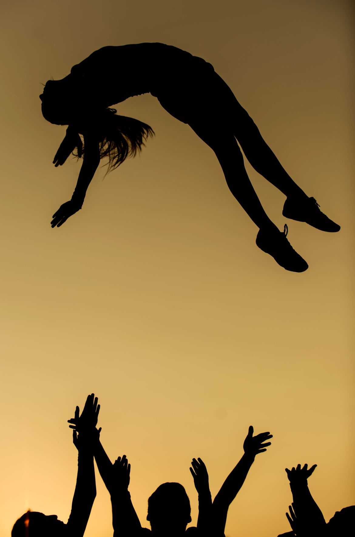 Rock Bridge cheerleader Brooklyn Woodruff arches her back in midair